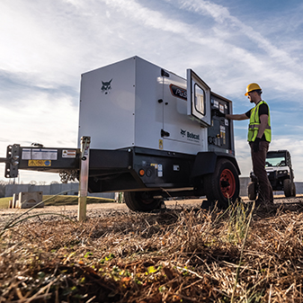 An Operator Adjusts Settings on a Bobcat Portable Generator for Air Compressor Sales, Inc. in Macon, GA 